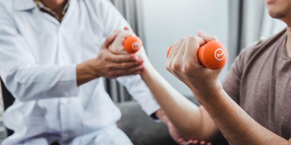 physiotherapist-man-doing-exercise-with-dumbbell